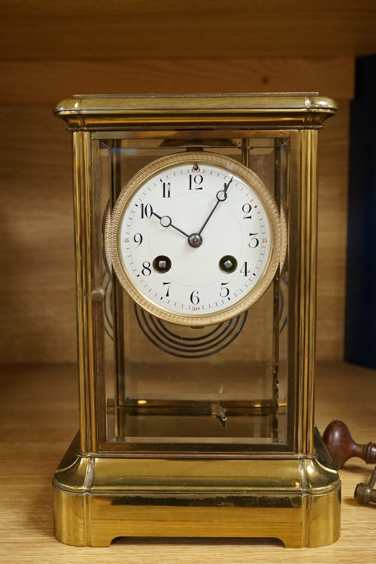 A four glass and brass mantel clock, 25cm high, 17cm wide.